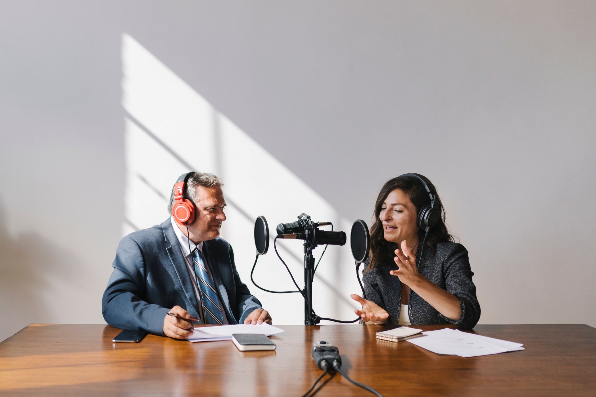 Female broadcaster interviewing her guest in a studio